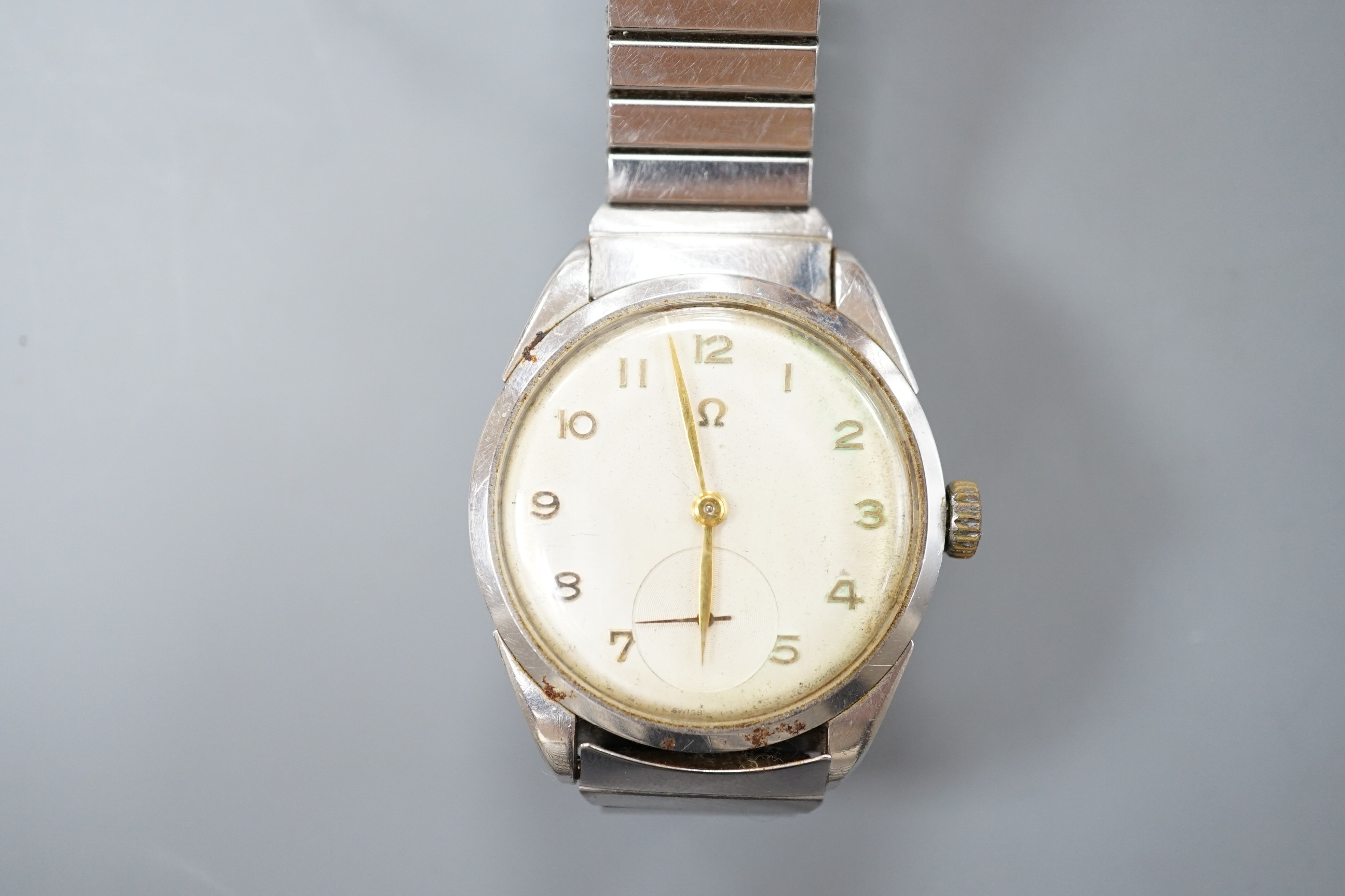 A gentleman's stainless steel Omega manual wind wrist watch, with Arabic dial and case back inscription, on associated flexible bracelet, case diameter 35mm.